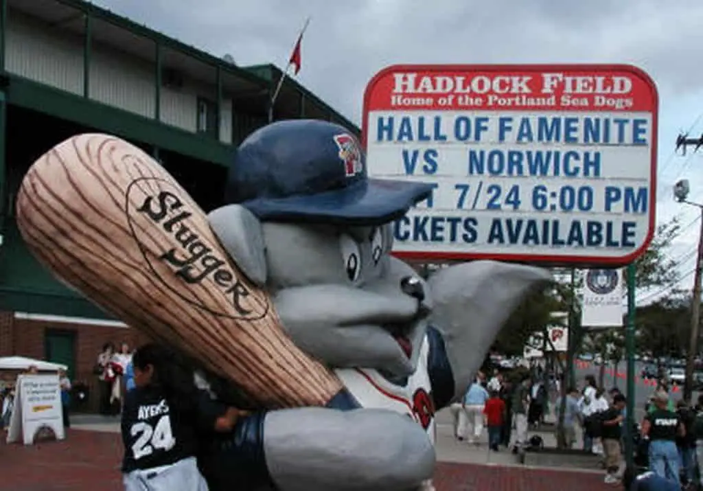 Hadlock Field sign with Slugger the Sea Dog mascot character in foreground.