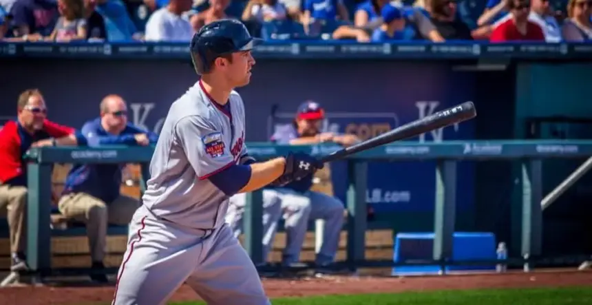 Player with composite baseball bat.