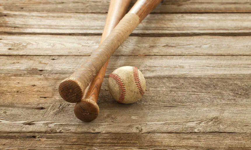 two wood baseball bats and a ball.