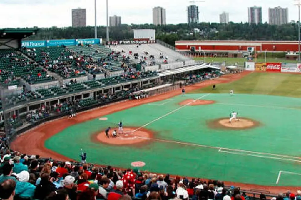 Baseball field with skyscraper in background.