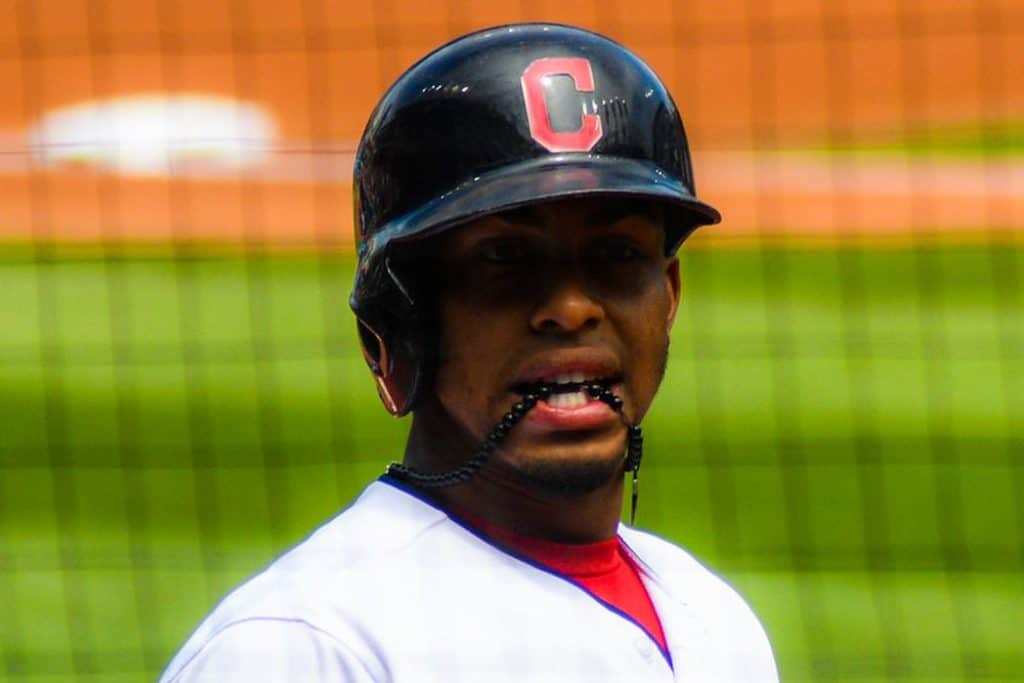 Baseball player with helmet covering one ear.