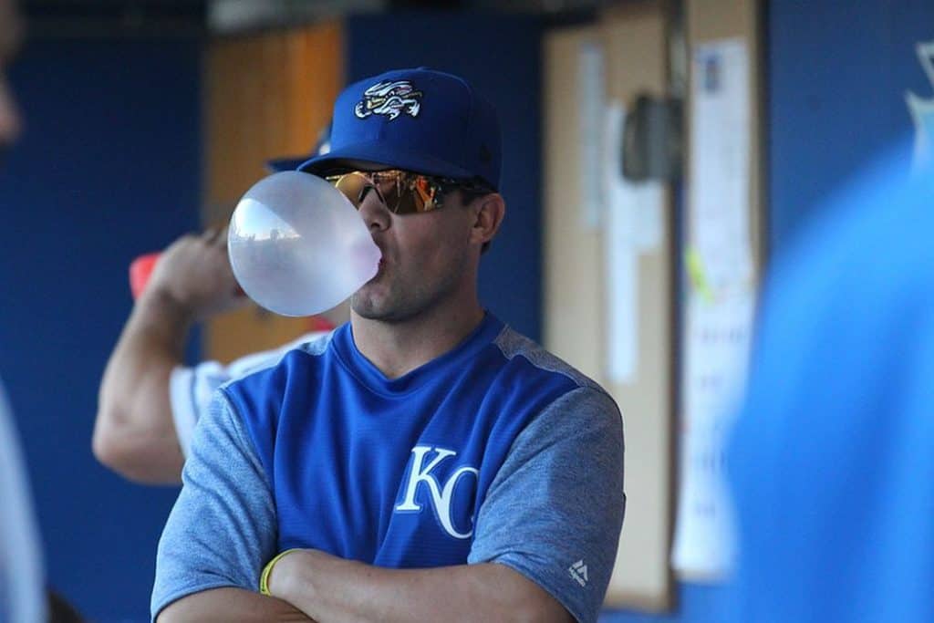 Baseball player making a gum bubble.