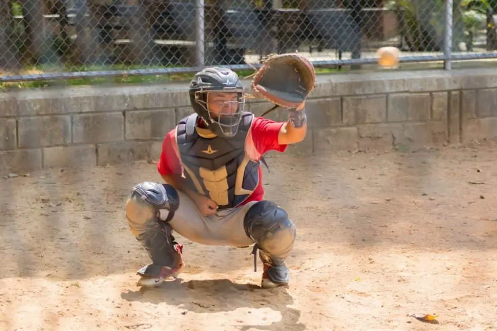 Baseball player catching a ball with his glove.