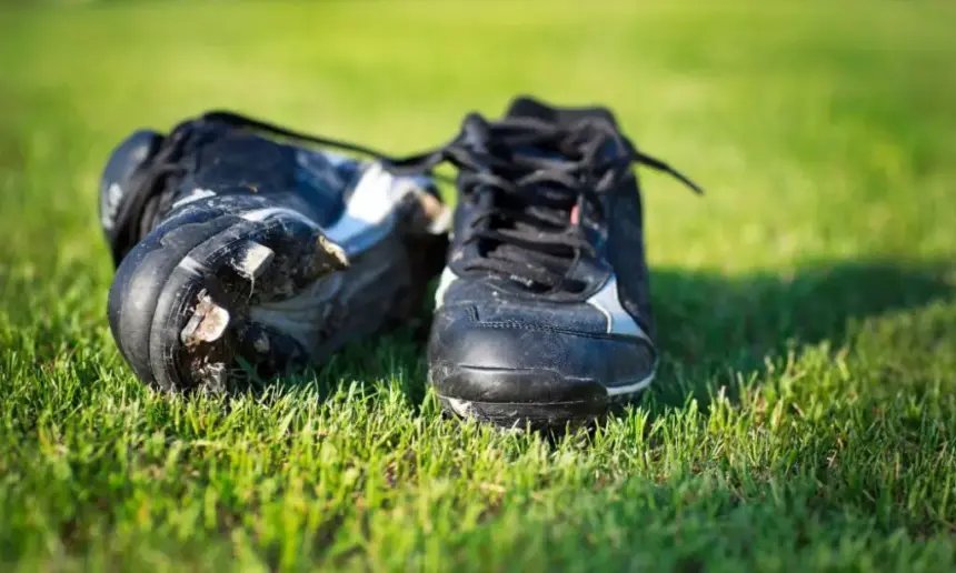 A worn pair of baseball cleats.