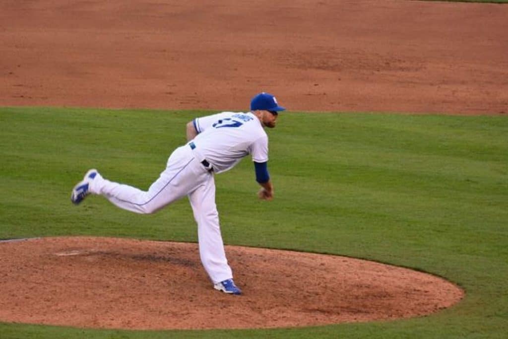 Baseball player pitching a ball.