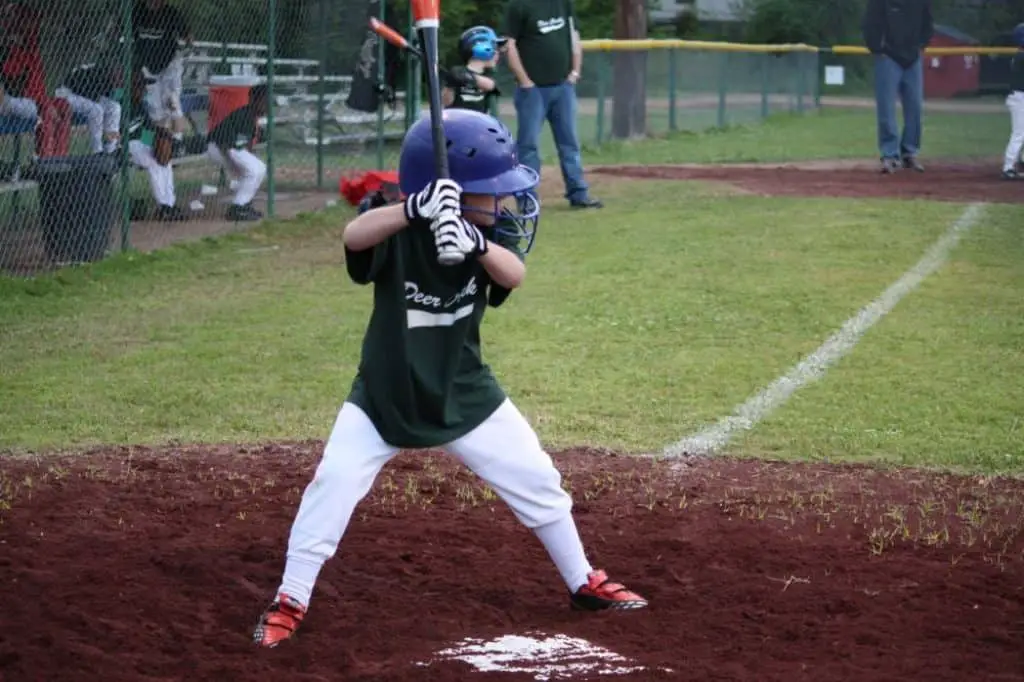 Young boy ready to bat at a travel baseball game.