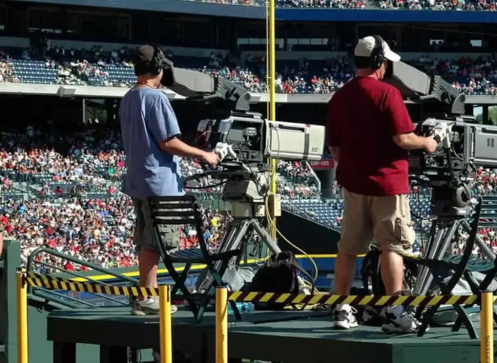 TV cameras film a baseball game.