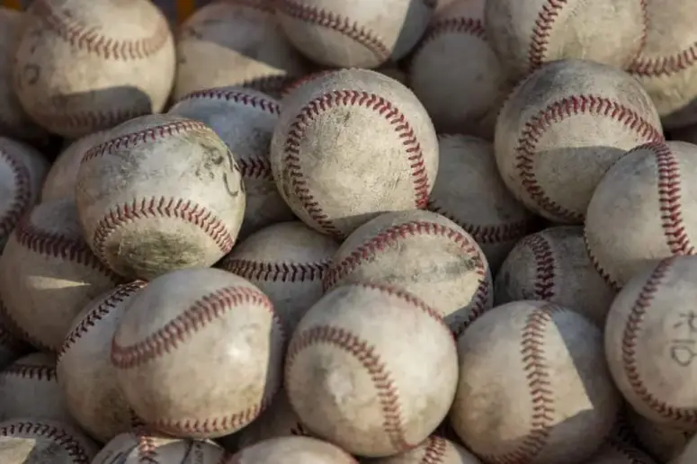 Bunch of used baseball balls.