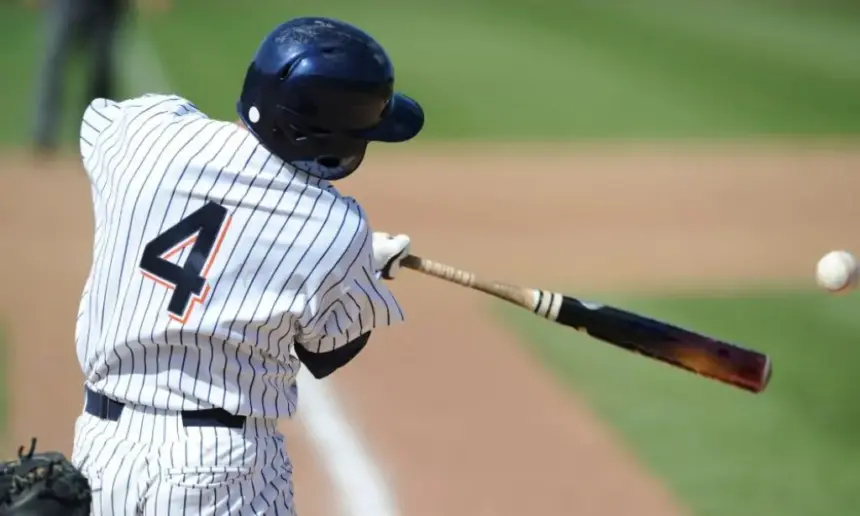 MLB batter hits the ball with a wooden bat.