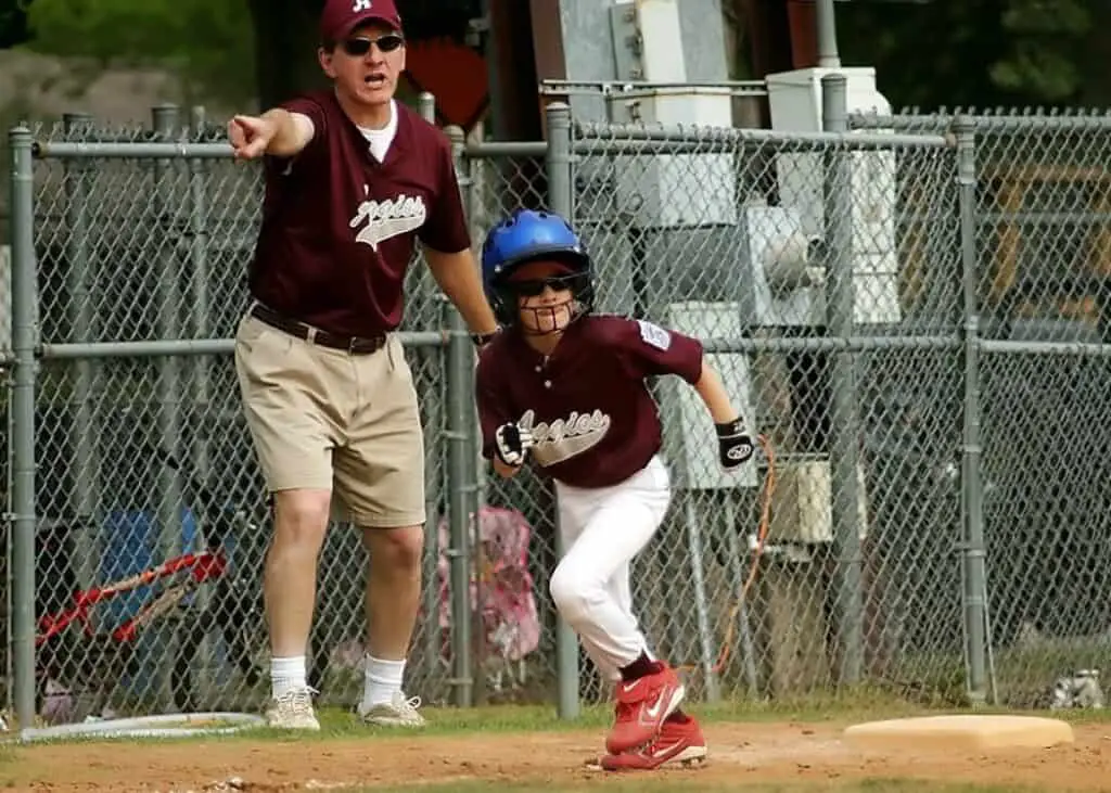 Baseball kid running at travel baseball tournament.