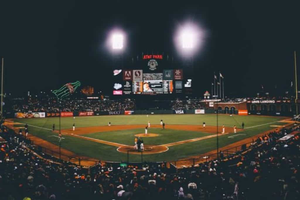 Baseball stadium at night with spotlight illumination.