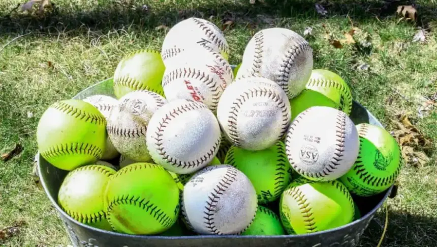 Bucket of baseballs and softballs.