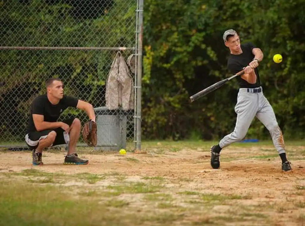 Male softball player batting.