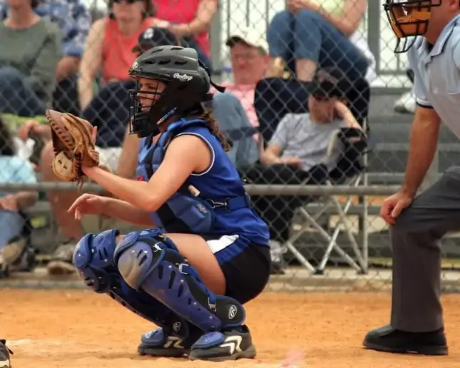 Female softball catcher and umpire in homebase.