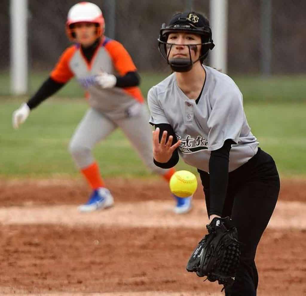 Softball player pitching a ball.