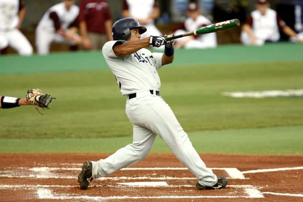 Baseball batter hitting the ball with a bbcor bat.