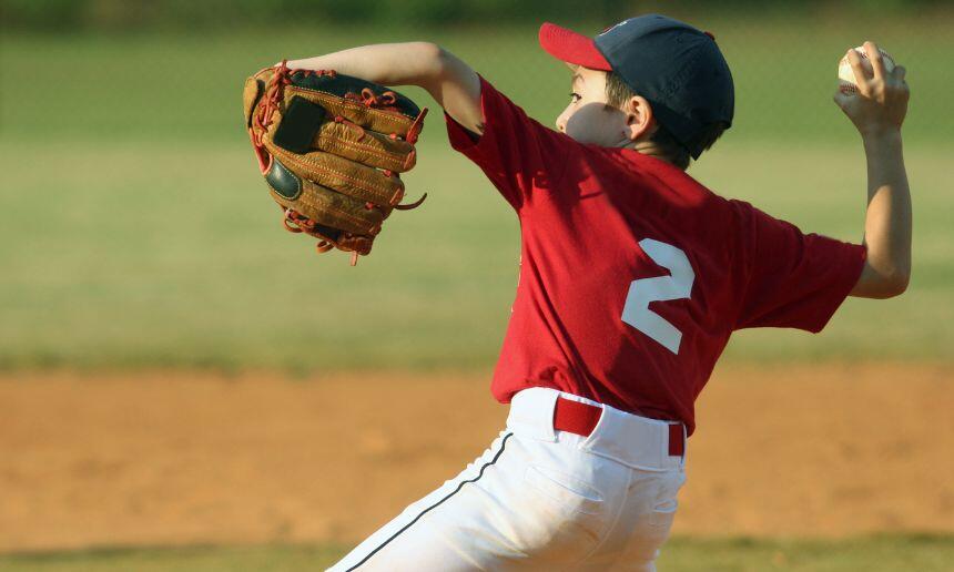 Young boy pitching overhand.