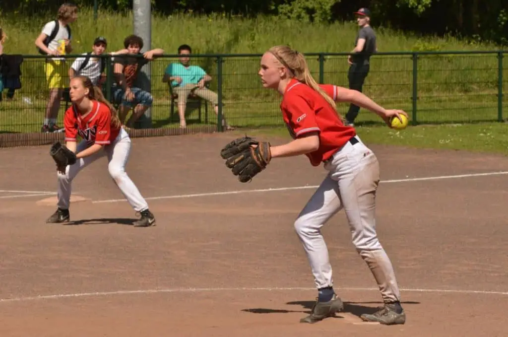 Female softball pitcher throwing a ball.