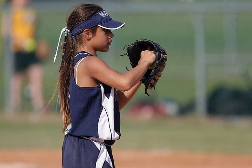 Young girl with softball glove.