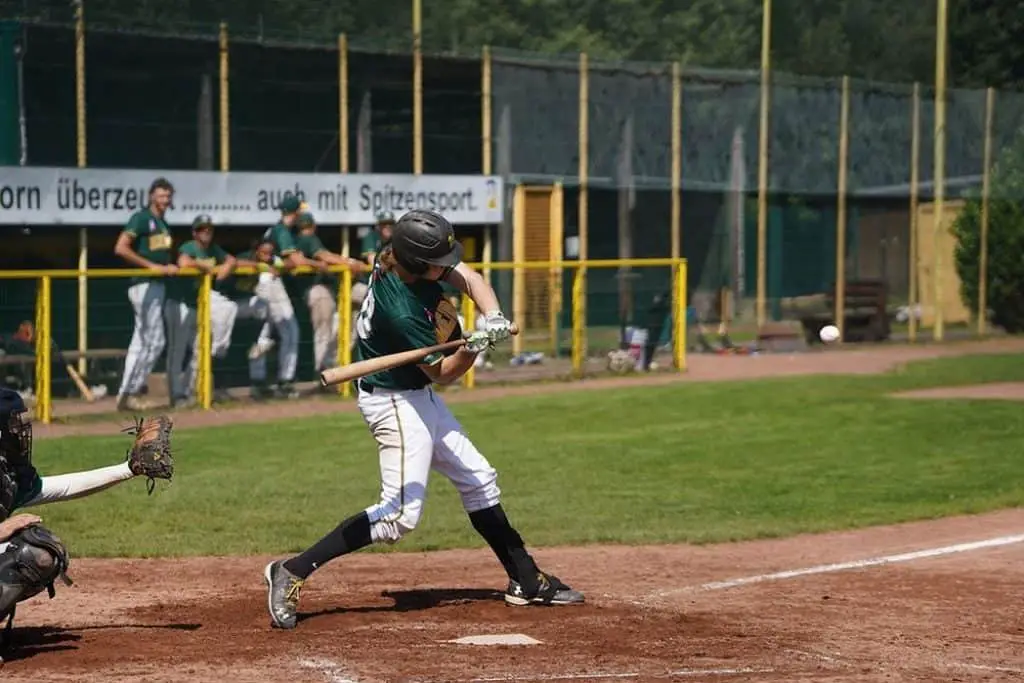 Batter trying to hit a flying baseball ball.