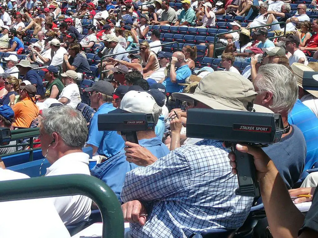 Baseball scouts with radar guns at a game.