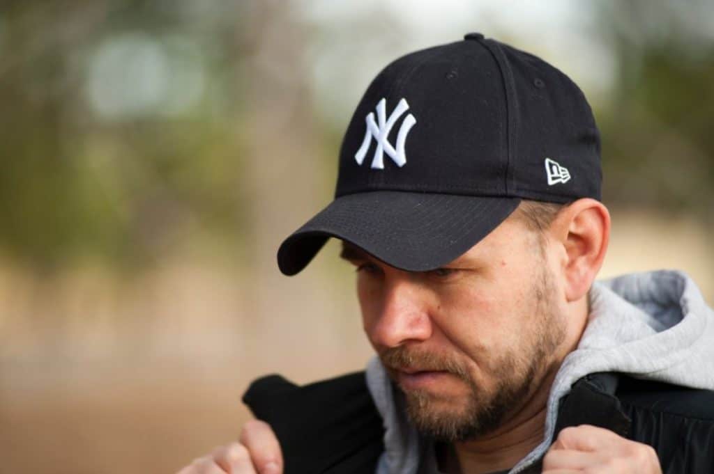 Man wearing a baseball hat.