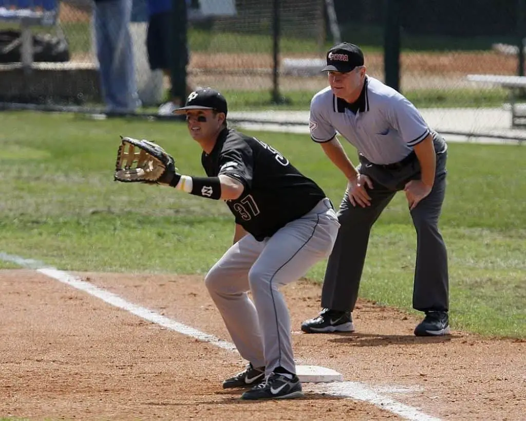 Baseball player and umpire in first base.