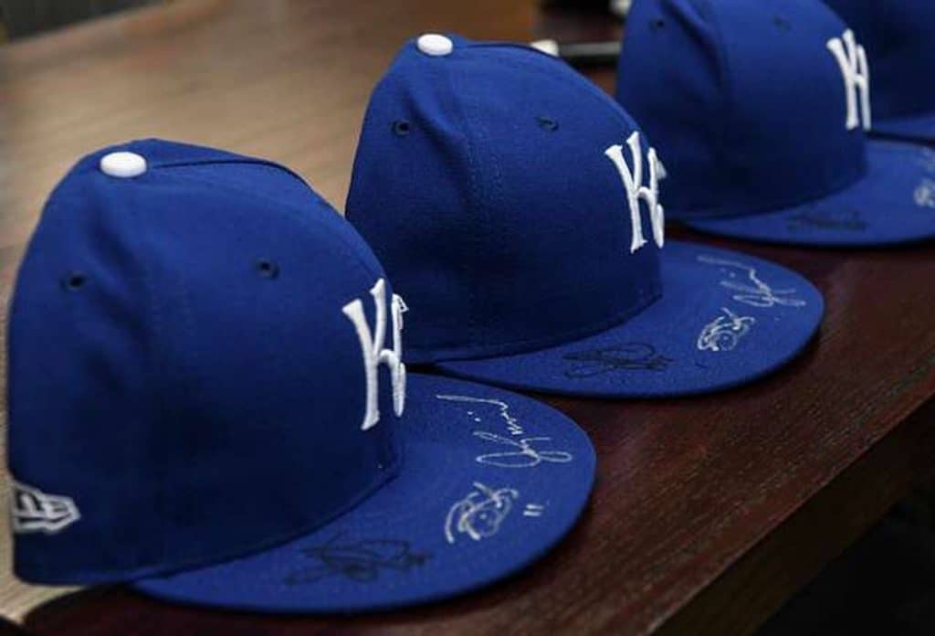 Three blue signed baseball caps.