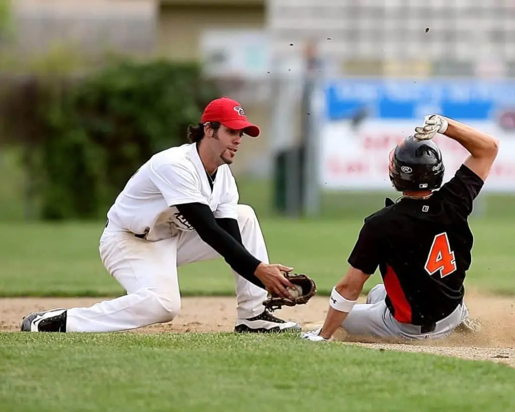 Two baseball players at shortstop position.