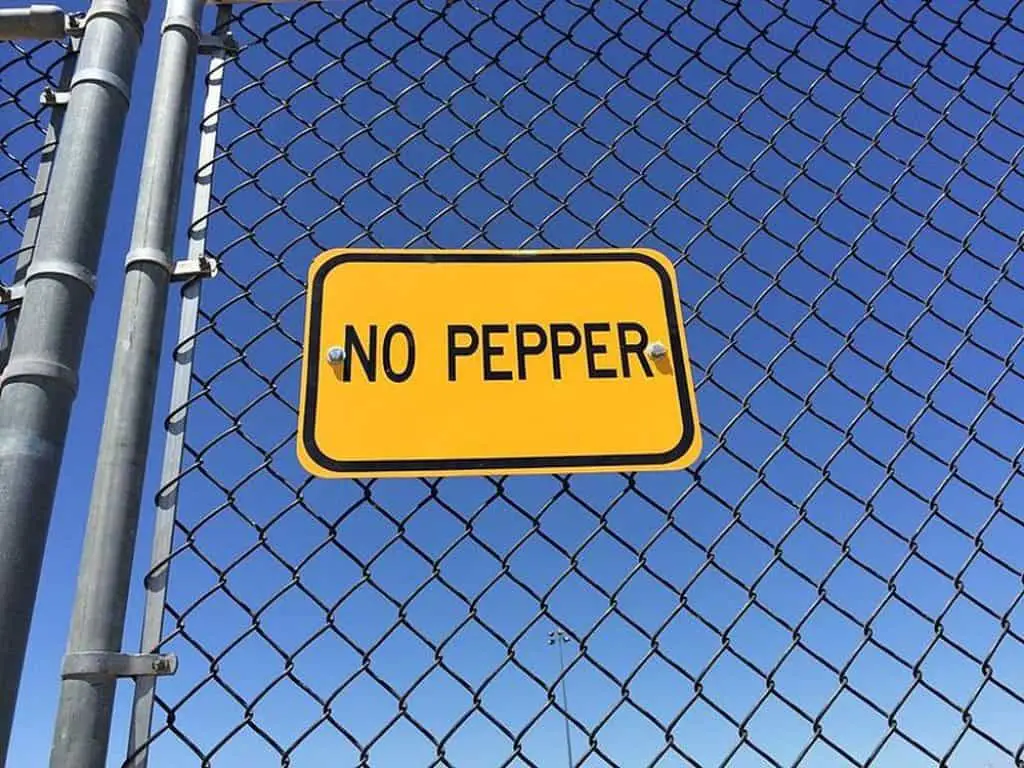 No pepper sign at fence of a baseball field.
