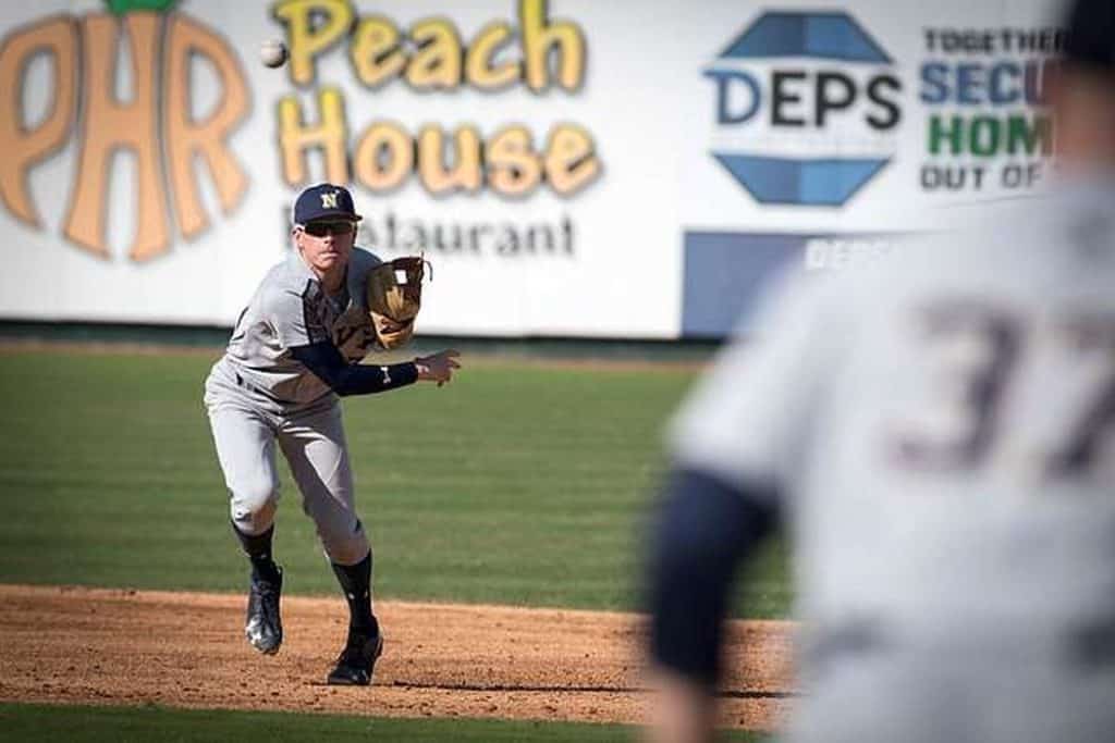 Baseball player throwing a ball in shortstop position.