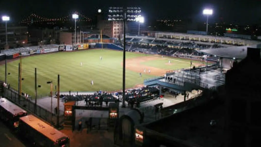 Fifth third field at night with floodlights.
