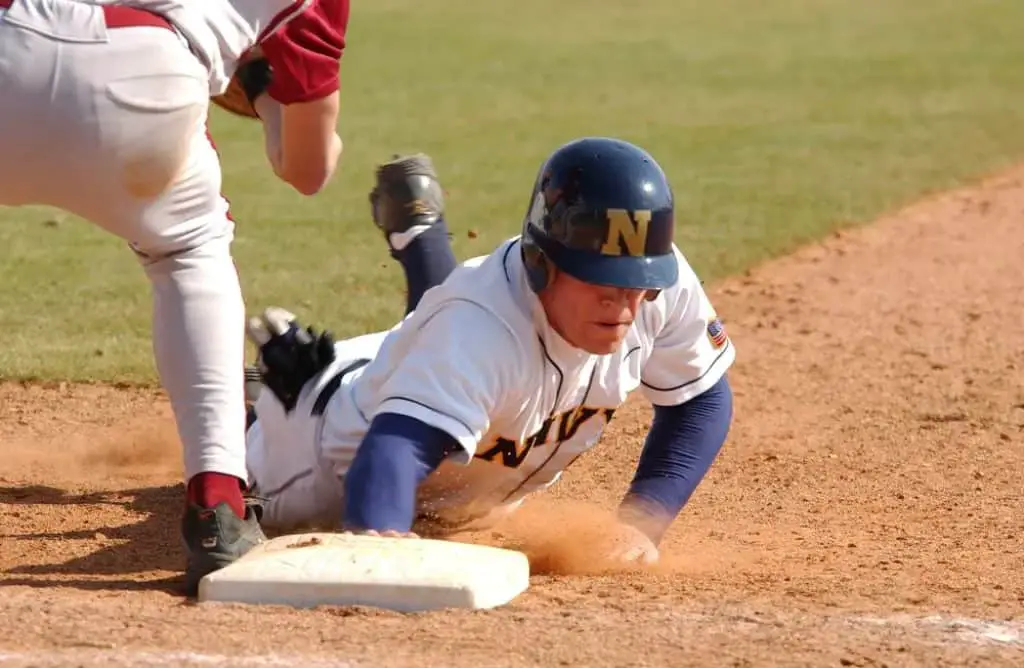 Baseball player stealing a base.