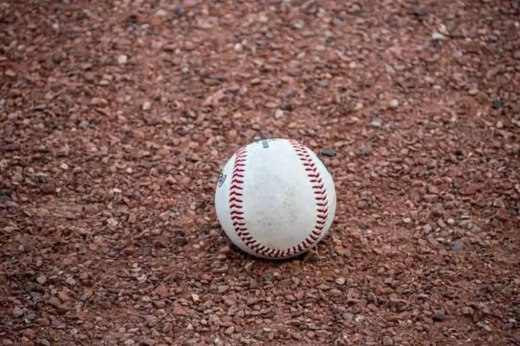 Baseball lying in the dirt.