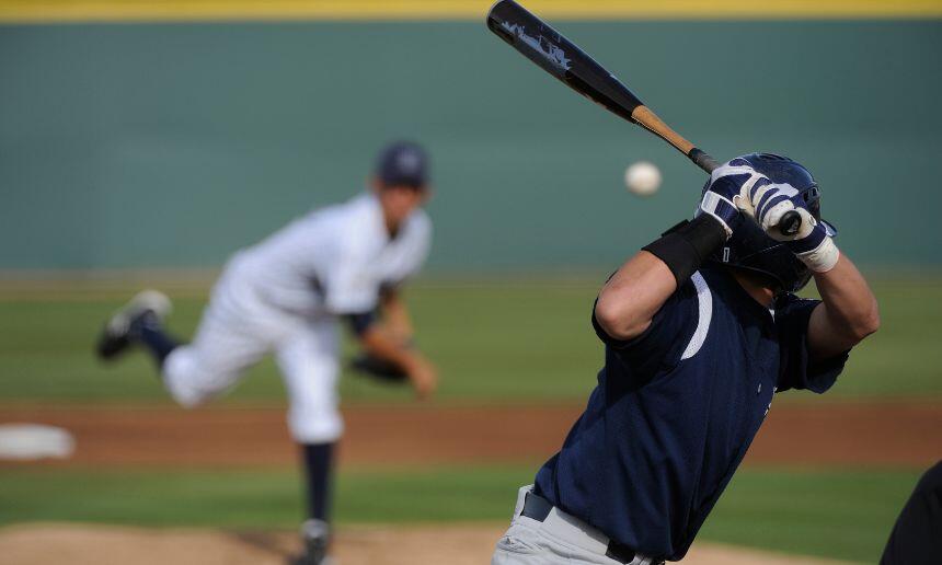 Baseball player hits a ball.