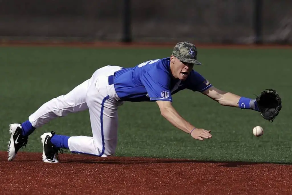 Baseball player on defense trying to catch a ball.