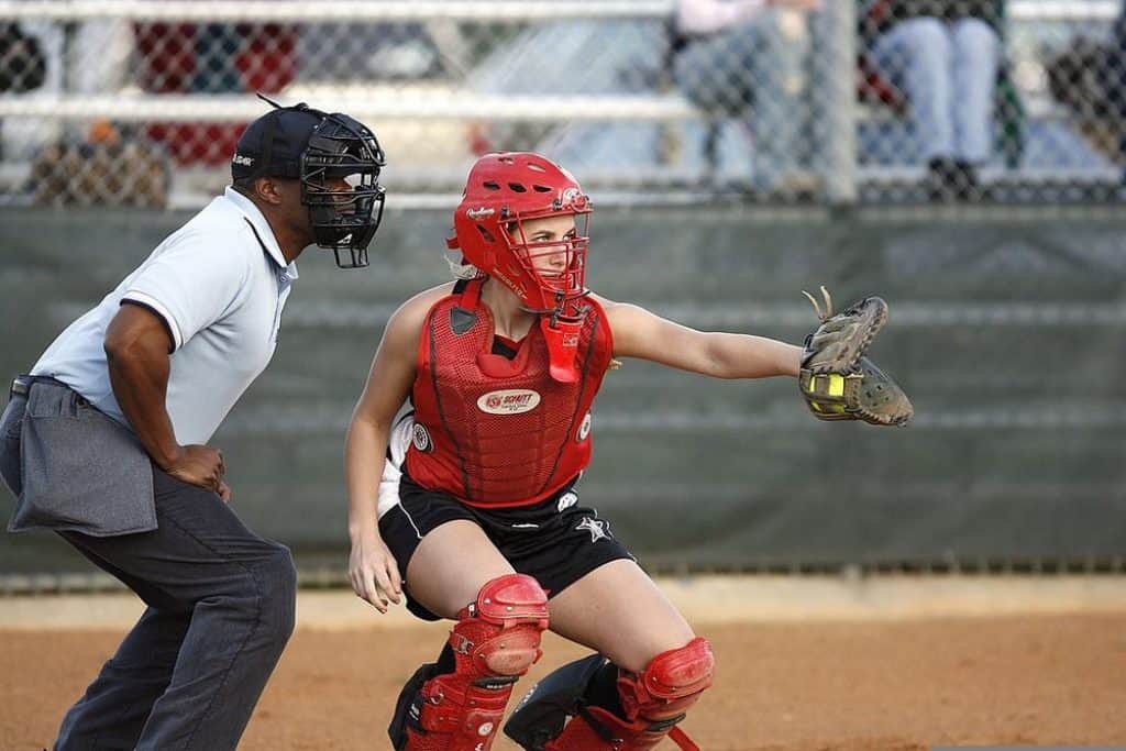 Softball umpire and catcher with face mask.