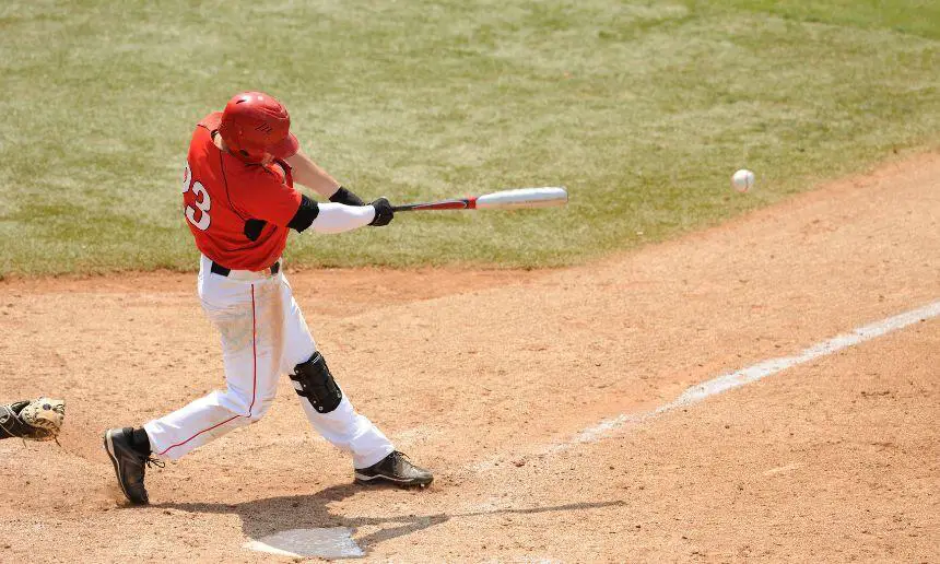 Baseball batter hitting a baseball.