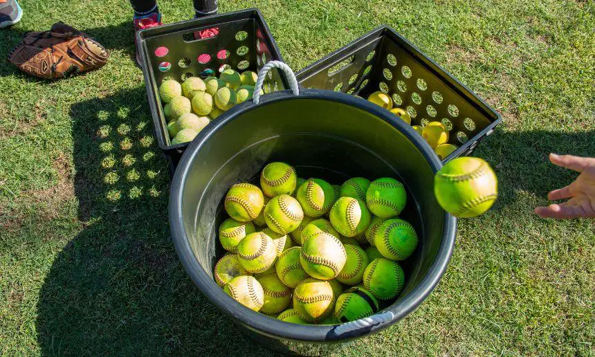 3 buckets full of softballs.